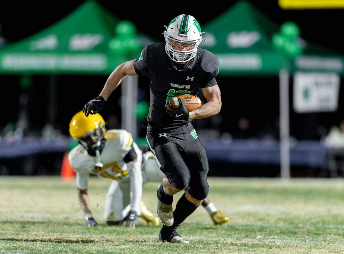 Weddington's Brody Anson (center) breaks through the Independence defense and runs for the first down. Weddington would host Independence in the NCHSAA quarterfinal playoff game Friday, Nov., 28 2025.