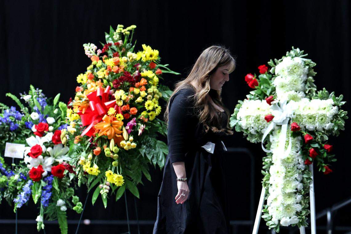 Jordyn Biffle, niece of former NASCAR driver Greg Biffle exits the stage after speaking at a Gathering in Remembrance ceremony on Friday at Bojangles Coliseum in Charlotte. The ceremony, Gathering in Remembrance was held for the seven people who died in a plane crash on Dec. 18, 2025, in Statesville. Among the group was former NASCAR driver Greg Biffle.
