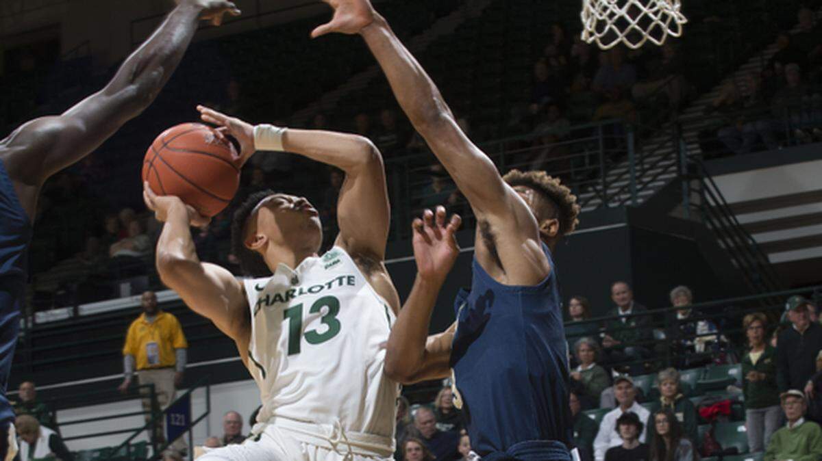 Charlotte’s Jordan Shepherd (13) goes to the basket against Florida International’s Trejon Jacob on Sunday.