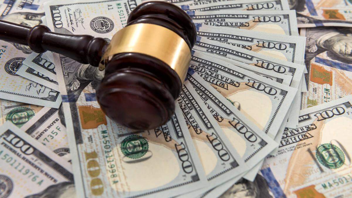Judge’s gavel on U.S. dollar banknotes.