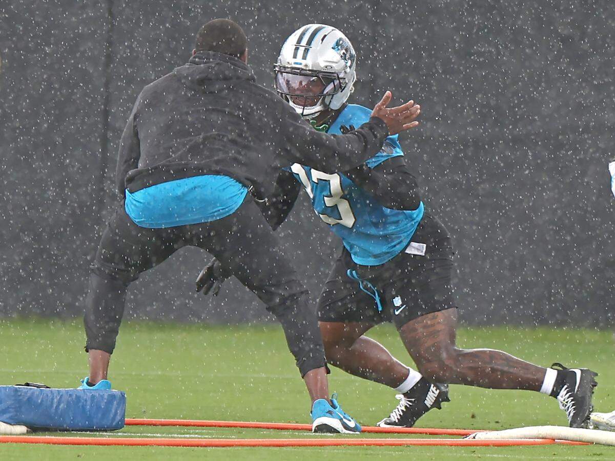 Carolina Panthers wide receiver John Metchie III, right, breaks off the line against a member of the team's personnel during the team's first open workout on Tuesday, May 26, 2026.