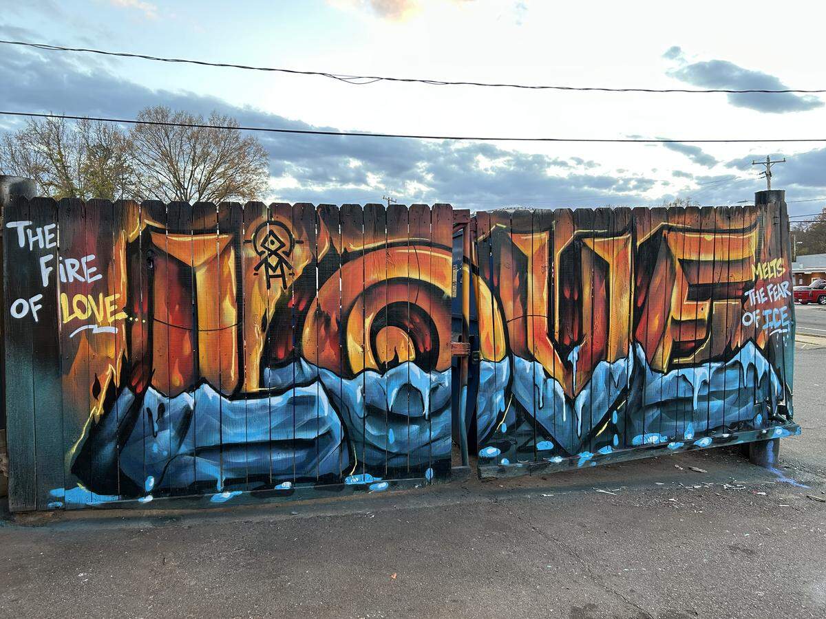 Artists Sydney Duarte and Treazy painted “the fire of love melts the fear of ICE” in response to federal immigration enforcement targeting Charlotte.