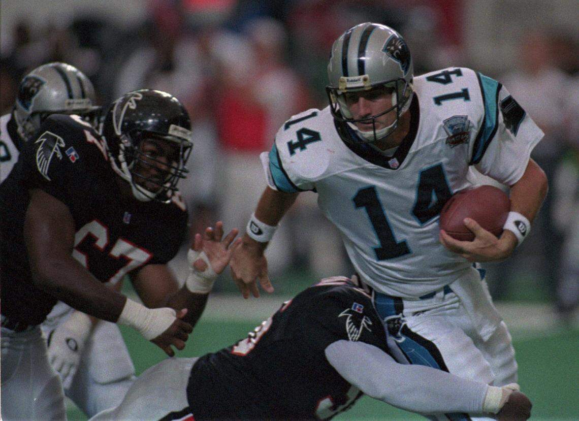 Quarterback Frank Reich tries to avoid Atlanta’s pass rush in Carolina’s first game in 1995. Reich threw for 329 yards in Carolina’s 23-20 loss, but was sacked nine times.