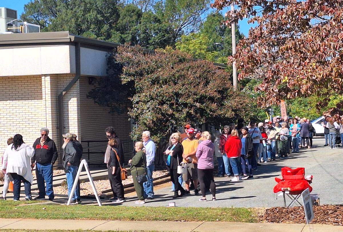 At least 200 voters were lined up outside the Iredell County Board of Elections in downtown Statesville around 12:20 p.m. Thursday on opening day of early voting.