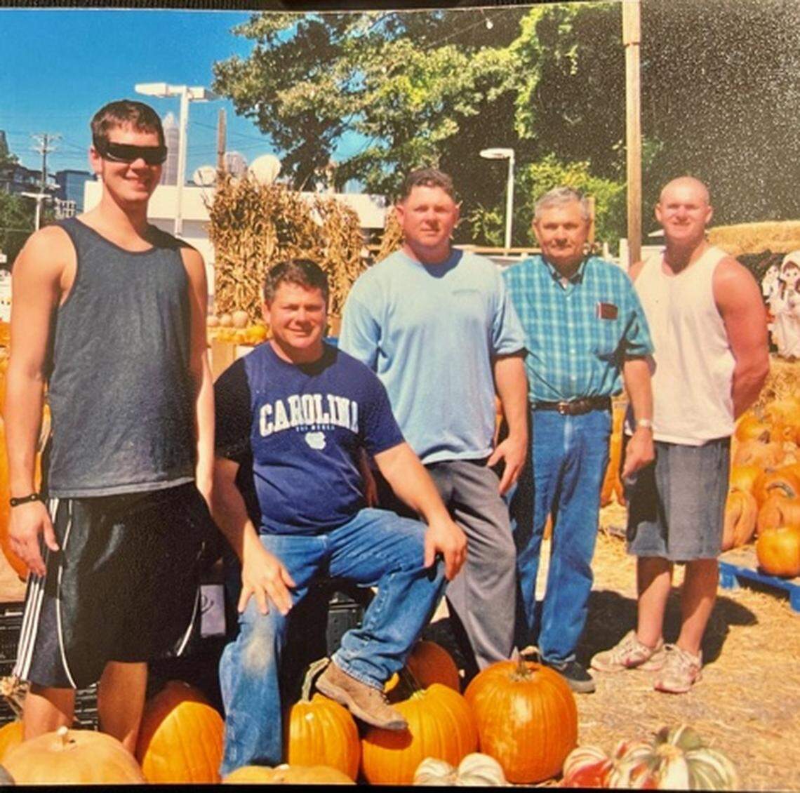 David Simpson, second from left, was a familiar face at his family’s farmer’s market and Christmas tree lot near Myers Park. He died last week due to complications from COVID-19. In this photo, he is shown with nephew, Jamie (far left), his brother Norman (center), his father Darrell (second from right) and his nephew Eric. Photo courtesy of the Simpson family.