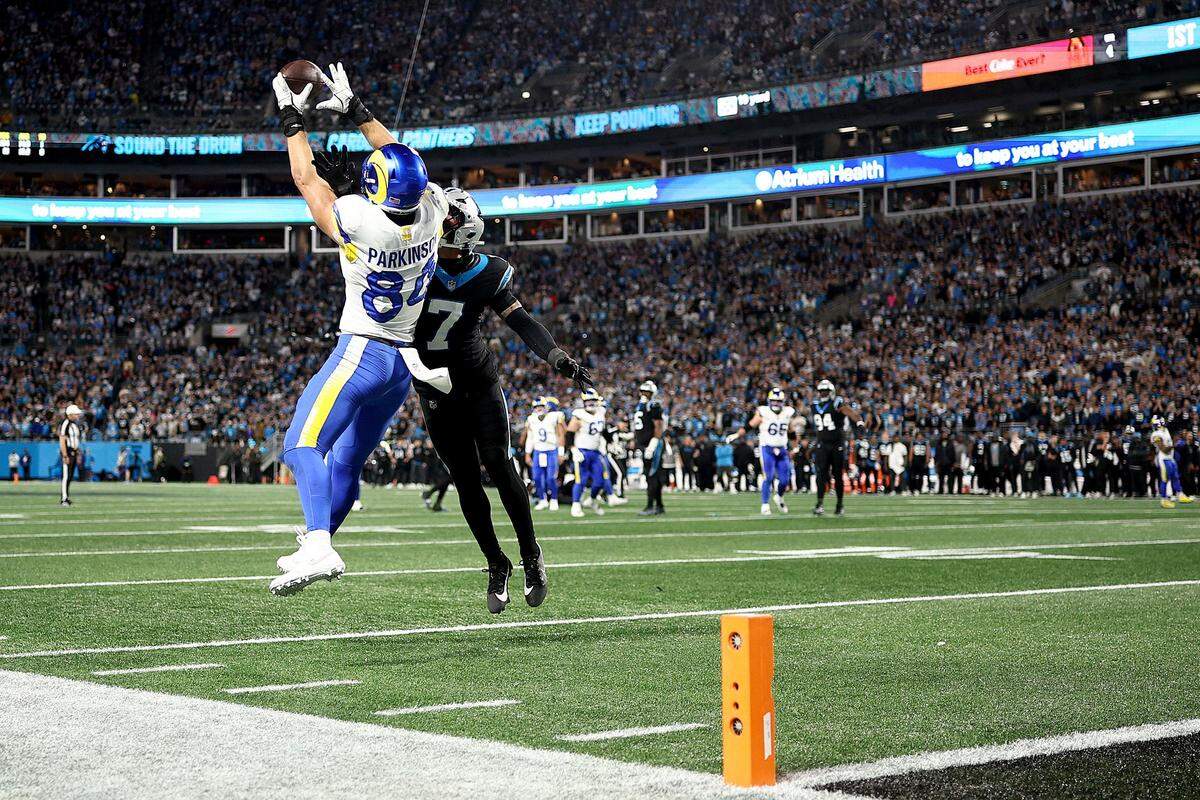 CHARLOTTE, NORTH CAROLINA - JAN. 10: Colby Parkinson #84 of the Los Angeles Rams catches a 19 yard touchdown pass against Tre'von Moehrig #7 of the Carolina Panthers during the fourth quarter in the NFC Wild Card Playoff game at Bank of America Stadium on Jan. 10, 2026 in Charlotte, North Carolina. (Photo by Jared C. Tilton/Getty Images)