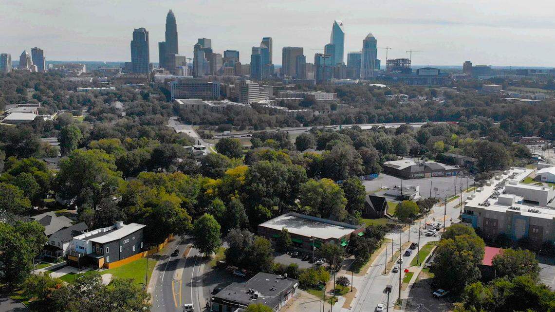 The Charlotte skyline rises in the background of the intersection of Beatties Ford Road, Rozzelles Ferry Road, Trade Street, and Fifth Street on October 20, 2020. Redevelopment is currently going on along the Beatties Ford Road corridor.