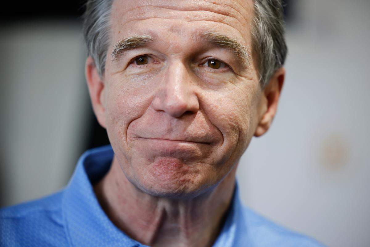 Gov. Roy Cooper speaks to the media before the Presidents Cup golf tournament at the Quail Hollow Club in Charlotte, N.C., Thursday, Sept. 22, 2022.
