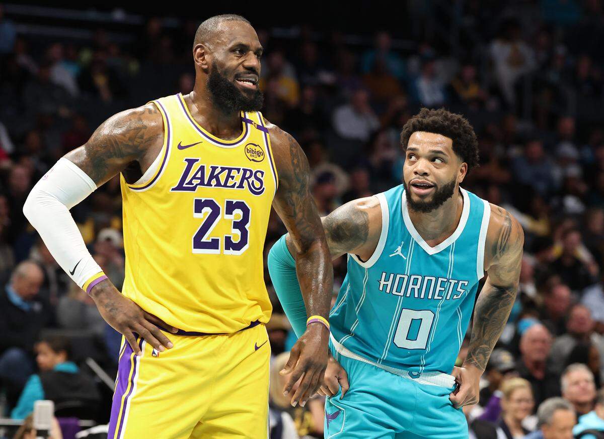 Charlotte Hornets forward Miles Bridges, right, glances up at Los Angeles Lakers forward LeBron James, left, as they stand along the lane during a free throw attempt at Spectrum Center in Charlotte, NC on Monday, January 27, 2025. The Lakers defeated the Hornets 112-107.
