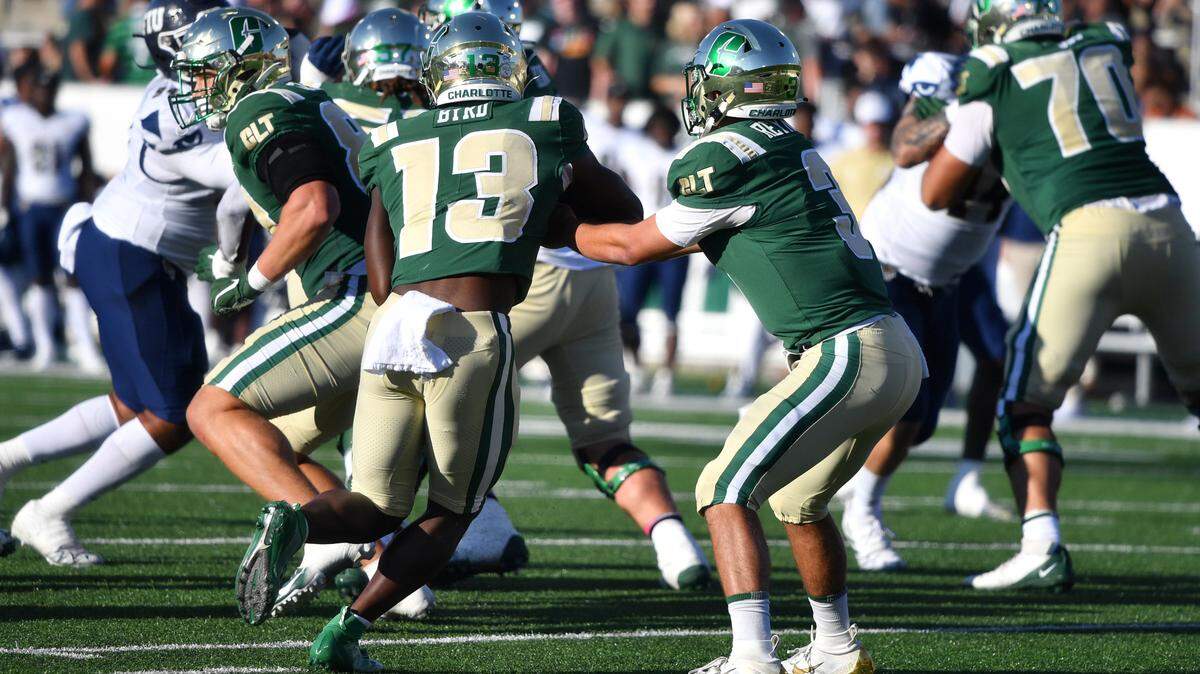 Chris Reynolds (3) hands off to Shadrick Byrd (13) in the first quarter of Charlotte’s homecoming-day loss against Florida International. The Charlotte 49ers lost to the Florida International University Panthers on Saturday, 34-15.