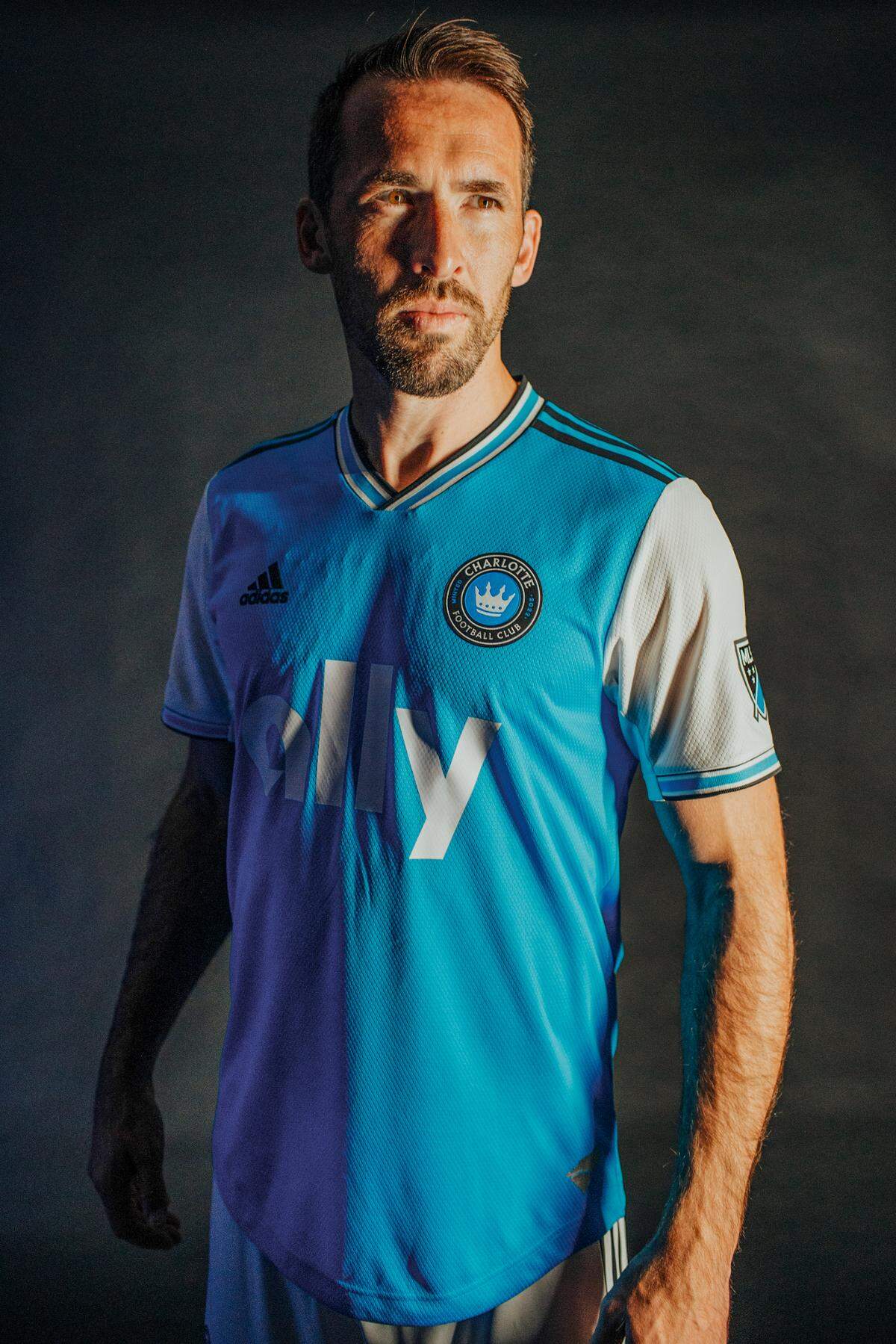 Charlotte FC player Christian Fuchs poses in the team’s inaugural primary uniform, which was unveiled Dec. 9, 2021.