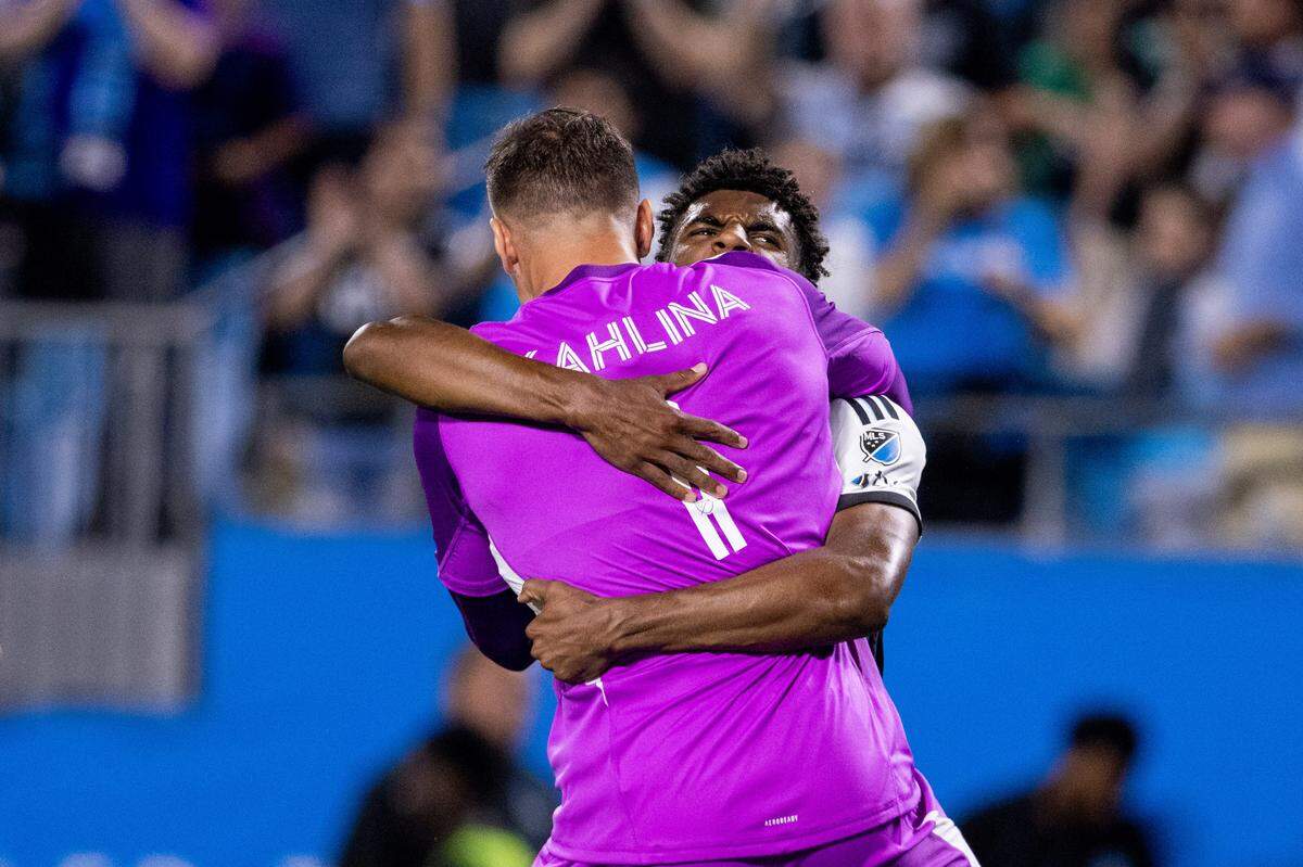 Charlotte FC goalkeeper Kristijan Kahlina (1) celebrates with defender Adilson Malanda (29) after Saturday’s win against the Columbus Crew at Bank of America Stadium.