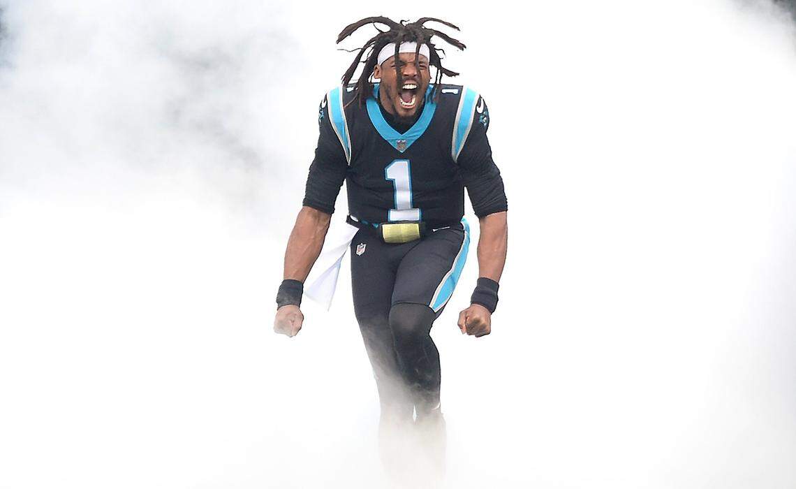 Carolina Panthers quarterback Cam Newton screams as he runs out of the smoke during player introductions at Bank of America Stadium in Charlotte, NC on Sunday, November 21, 2021. The Panthers host the Washington football team.
