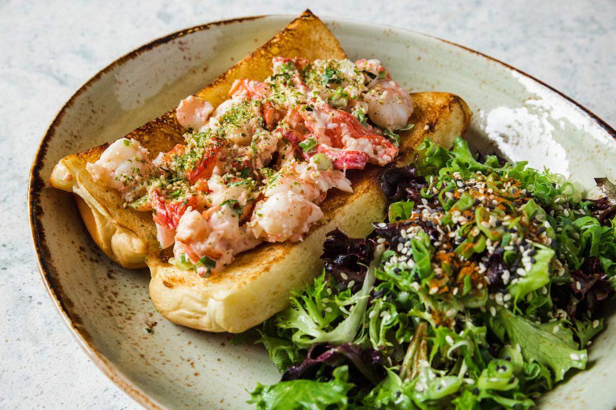 Fin & Fino’s lobster and shrimp roll, with&nbsp;mayo, lime, togarashi, sesame, chilled salad on a roll.