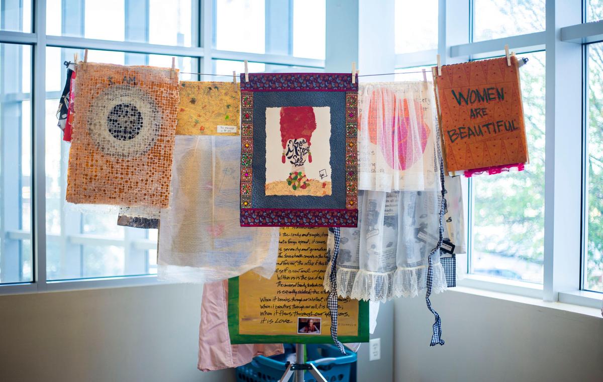 Artwork from one of Andrea Downs’ ”Laundry Day” workshops hangs on a line like laundry might. At this February “Airing Out the ‘Dirty’ Laundry” workshop women of all gender expressions used visual art as a way to tell their stories, ranging from stories about the silencing of women to those about personal moments of strength and empowerment.