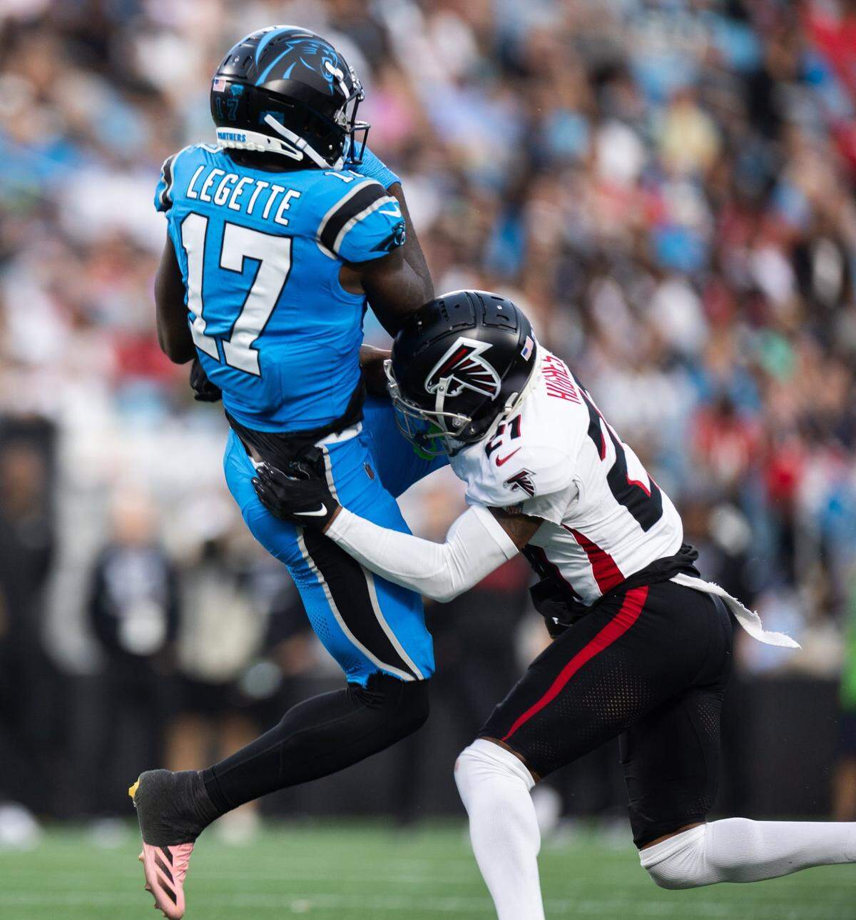 Carolina Panthers wide receiver Xavier Legette, left, is tackled by Atlanta Falcons cornerback Mike Hughes after catching a pass at the Bank of America Stadium in Charlotte, N.C. on Sunday, October 13, 2024.