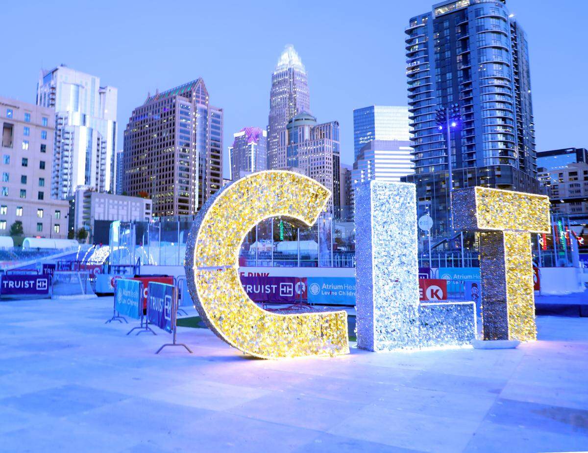 The large, illuminated marquee letters C-L-T implicate the cityscapes surrounding Truist Field while adding a festive touch to the area for the 5th Annual Light the Knights Festival, November 26, 2024, in uptown Charlotte, North Carolina. The festival is a bright celebration filled with holiday cheer, featuring an array of dazzling light displays like this one.