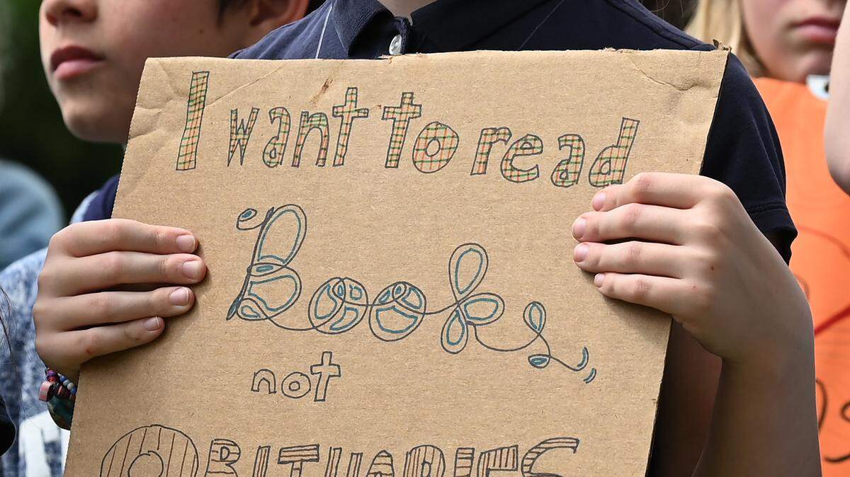 A Trinity Episcopal School student holds a sign during a walk out in April. Students called for action on gun violence and gun safety.