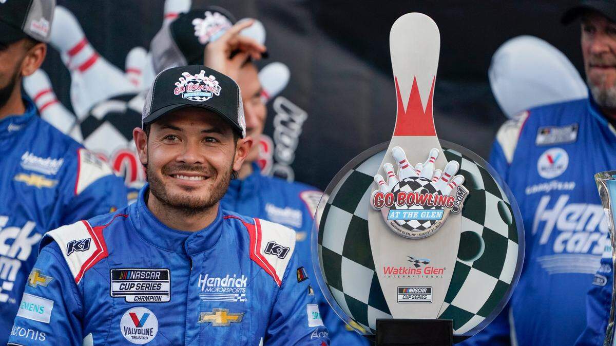 Kyle Larson smiles with his trophy after winning a NASCAR Cup Series auto race in Watkins Glen, N.Y., Sunday, Aug. 21, 2022. (AP Photo/Seth Wenig)
