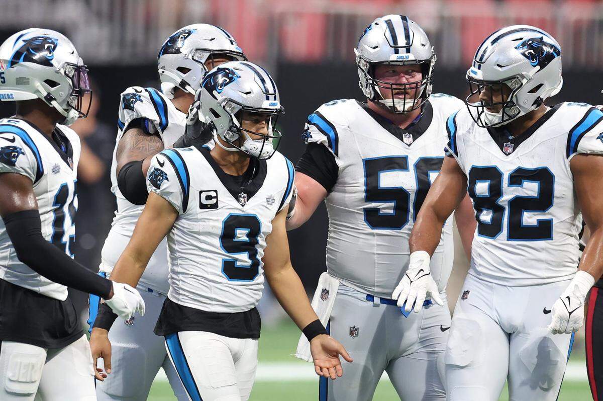 Members of the Carolina Panthers console quarterback Bryce Young, right, after he was tackled on a run during fourth-quarter action against the Atlanta Falcons at Mercedes-Benz Stadium in Atlanta, GA on Sunday, September 10, 2023. The Falcons defeated the Panthers 24-10.