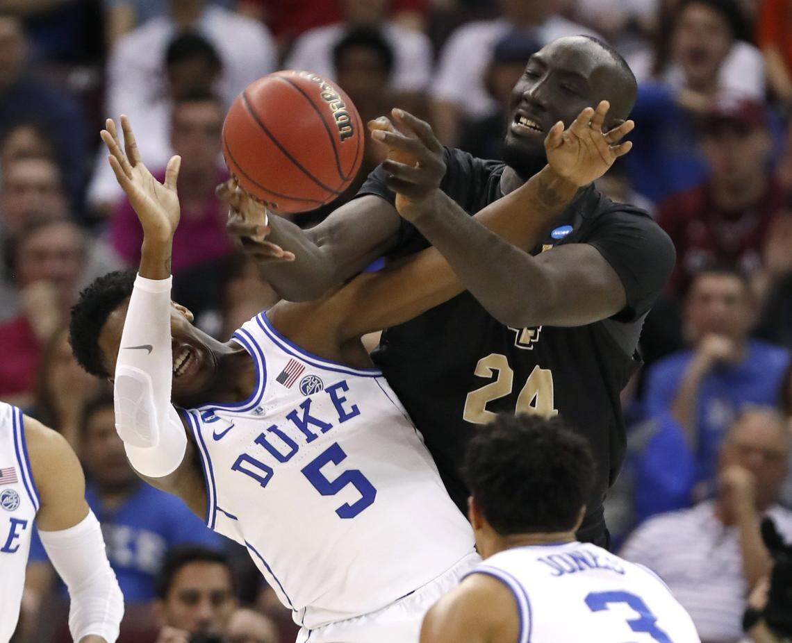 UCF’s Tacko Fall (24) fights for a rebound with Duke’s RJ Barrett (5) during the first half of Duke’s game against UCF in the second round of the NCAA Men’s Basketball Championship in Columbia, S.C., Sunday, March 24, 2019.