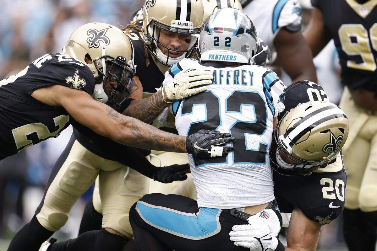 Carolina Panthers running back Christian McCaffrey (22) is tackled by four New Orleans Saints during a game at Bank of America Stadium in Charlotte, N.C., Sunday, Sept. 25, 2022. Because so much of the Panthers’ offense was centered around McCaffrey, he often faced defenses primed to stop him.