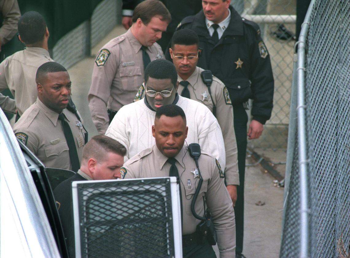 Deputies lead condemned serial killer Henry Louis Wallace to a van to transport him to Central Prison in Raleigh on in January 1997.