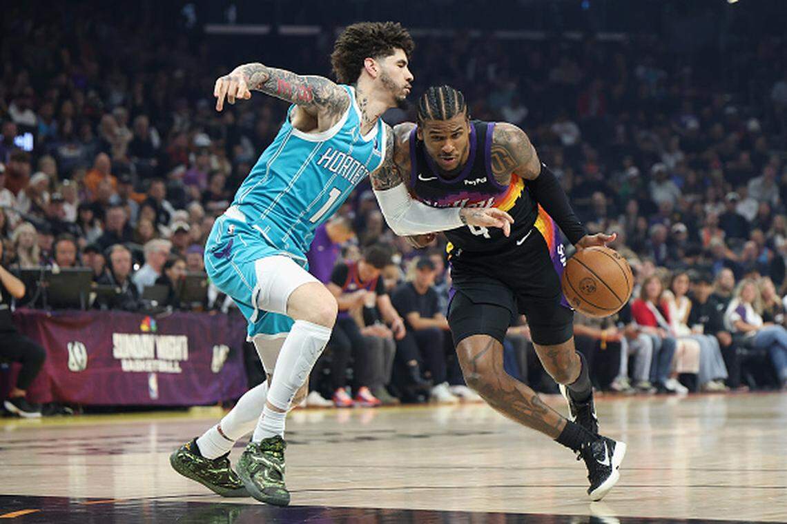 Jalen Green of the Phoenix Suns drives the ball past LaMelo Ball of the Charlotte Hornets during the first half of the NBA game at Mortgage Matchup Center.