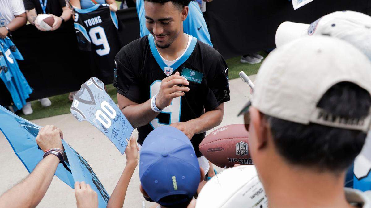Carolina Panthers quarterback, Bryce Young, signs autographs with fans after a Training Camp practice on Saturday, July 29, 2023.
