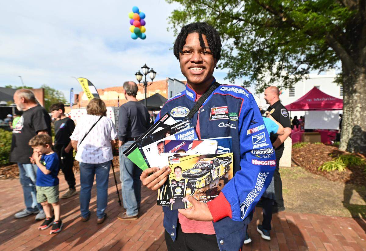 NASCAR fan Christopher Turner-Blue proudly shows off his collection of NASCAR XFINITY Series and Craftsman Truck Series drivers along with former stars Kenny Wallace and Ken Schrader autographs he obtained during Thunder Fest in downtown Rockingham, NC on Thursday, April 17, 2025. Fans are celebrating the return of the NASCAR Craftsman Truck Series and XFINITY Series to Rockingham Speedway this weekend.