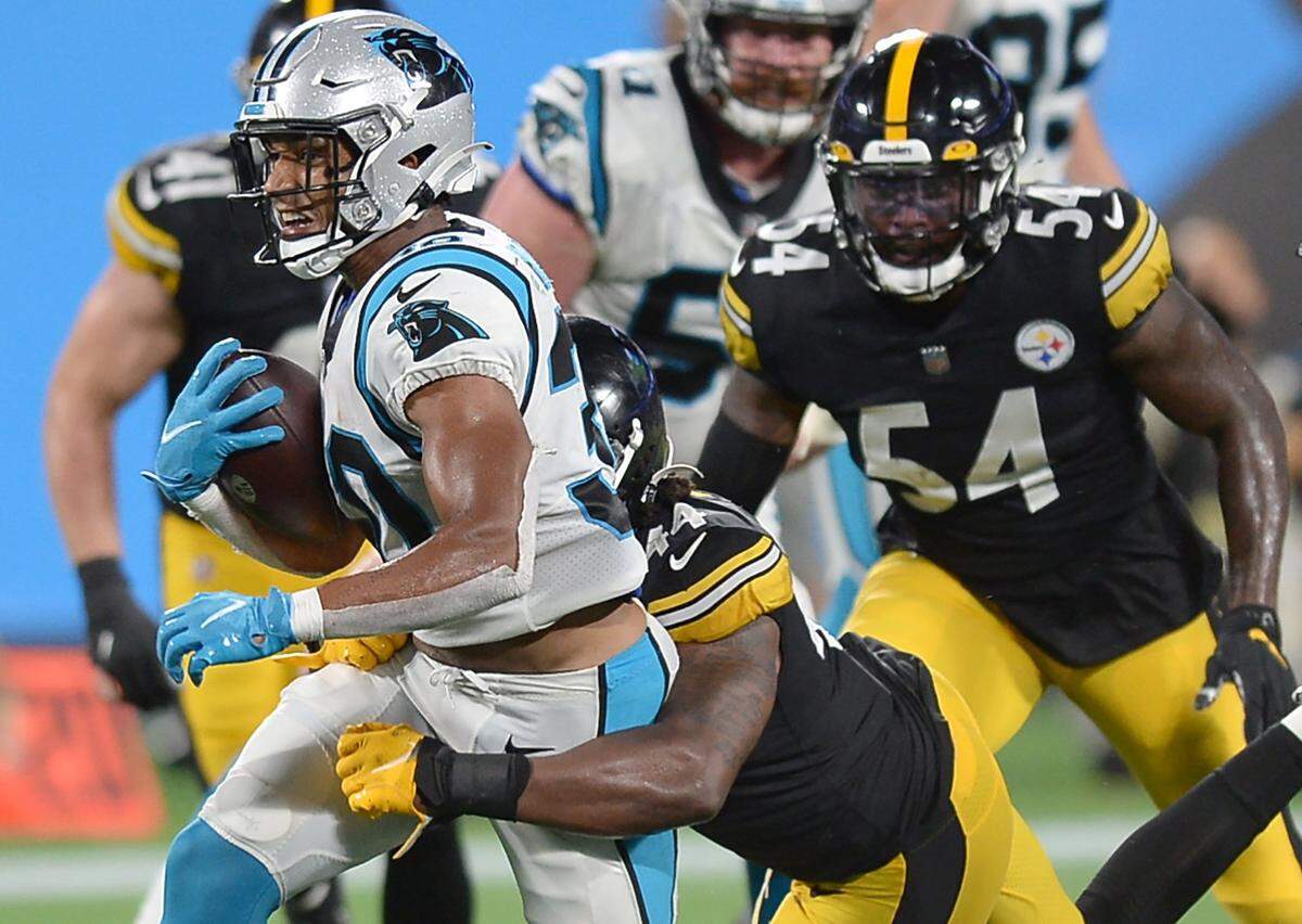 Carolina Panthers running back Chuba Hubbard, center, fights for yardage against the Pittsburgh Steelers during second quarter action at Bank of America Stadium in Charlotte, NC on Friday, August 27, 2021.