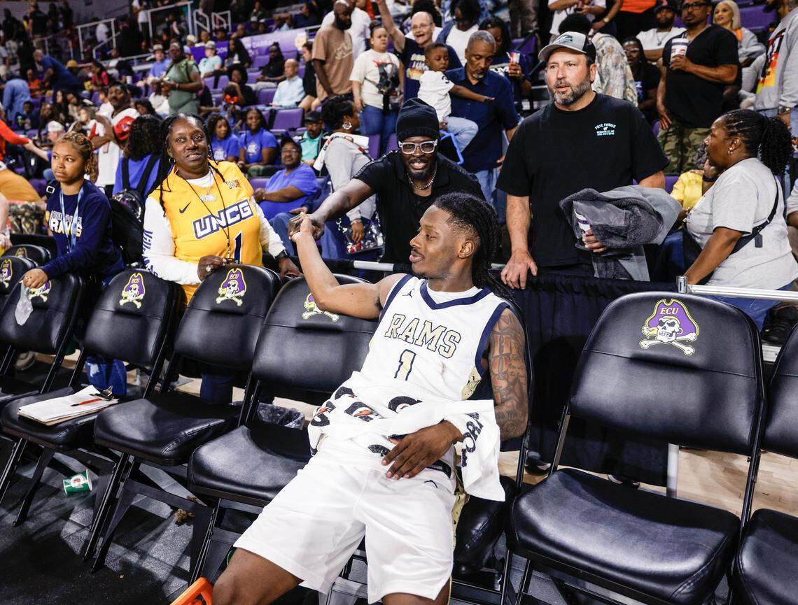 Reidsville point guard Dionte Neal (1) is congratulated by a fan after winning the NCHSAA 4-A Eastern Regional Basketball Championship game over Washington at Eastern Carolina University in Greenville, N.C., on Saturday, March 7, 2026.