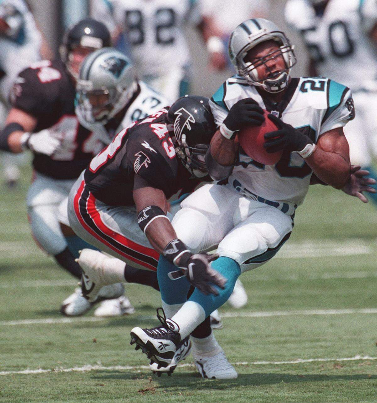 In 1998, Carolina’s Winslow Oliver takes a hard hit from Atlanta’s Juran Bolden. Oliver estimates he suffered at least 10 concussions during his football career.
