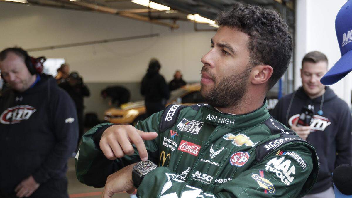 Bubba Wallace motions to his crew about time left before getting in his car during practice for the Daytona 500 at Daytona International Speedway in 2020. Wallace says his goal is to win two races this year.