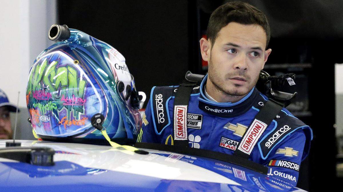 Kyle Larson gets ready to climb into his car to practice for the NASCAR Daytona 500 auto race at Daytona International Speedway, Friday, Feb. 14, 2020, in Daytona Beach, Fla. (AP Photo/Terry Renna)