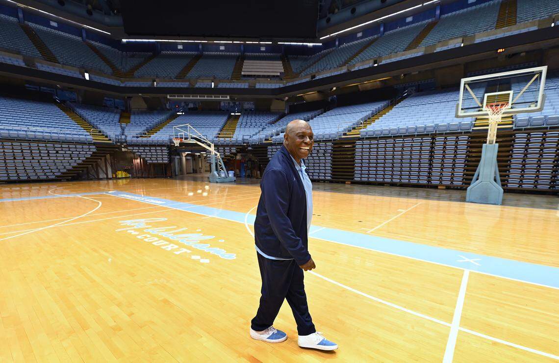 UNC Chapel Hill basketball legend Phil Ford walks across Roy Williams Court at the Smith Center in Chapel Hill, NC joking with head coach Hubert Davis on Wednesday, June 1, 2022. UNC head coach Dean Smith used the four corners offense under Ford at point guard.