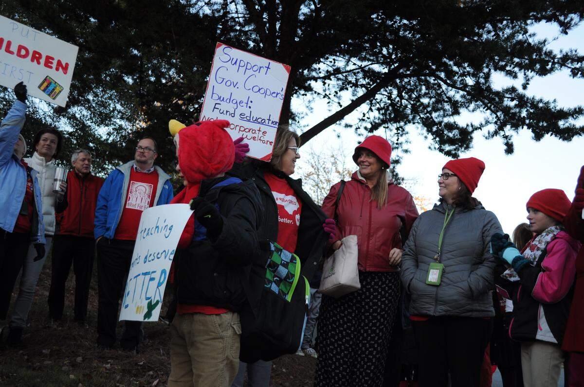 Teachers and their children demonstrated outside Waddell Language Academy in Charlotte on Wednesday, in support of higher raises and funding for school support staff from the statehouse.
