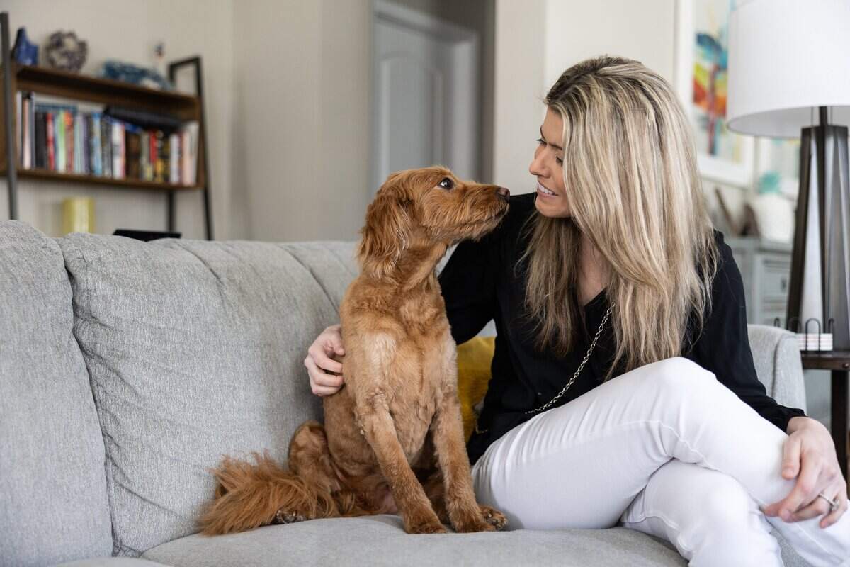 McKinnon Galloway sits with her dog, Ellie, at home in Cornelius, N.C., on Thursday, March 20, 2026.