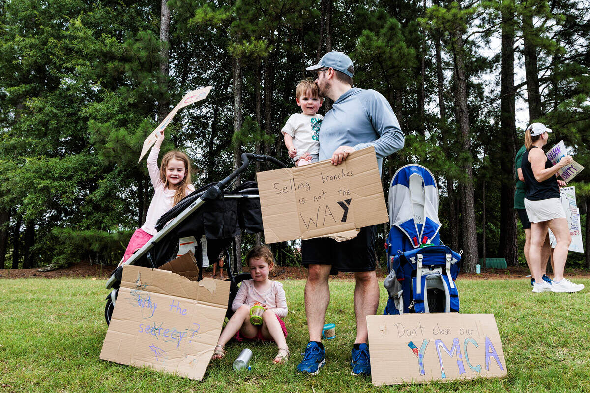 The Walker family protests the sale of the Morrison Family YMCA campus in Ballantyne to Moments of Hope Church on Sunday, July 12, 2026.