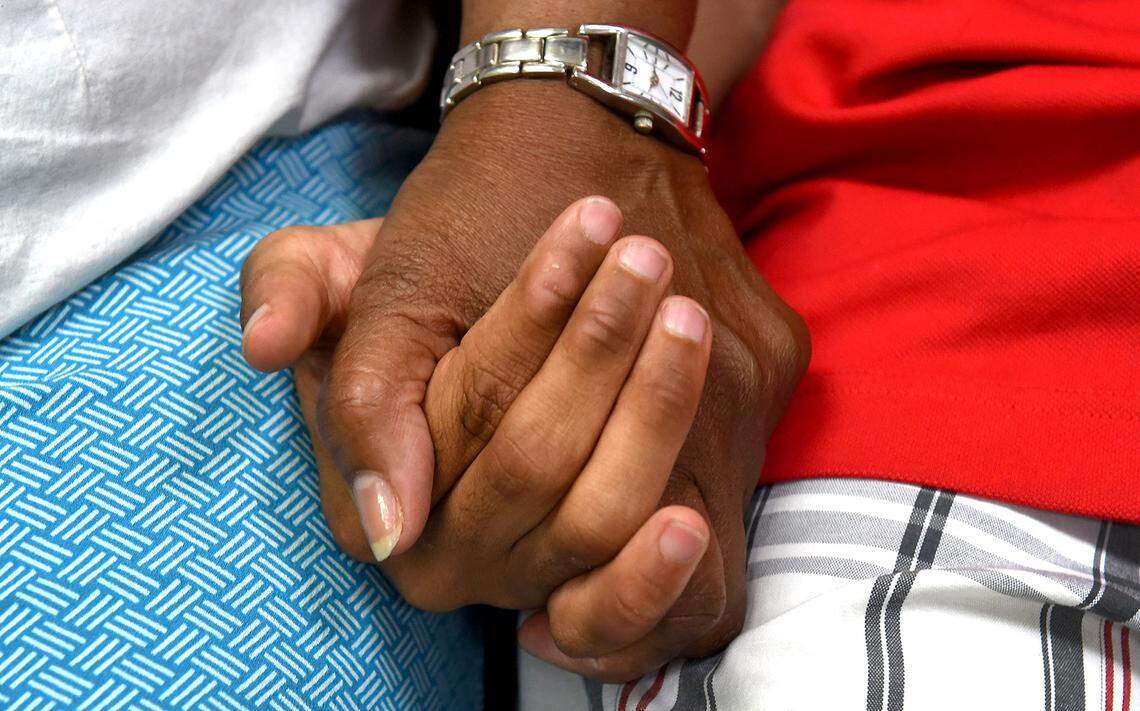 Saundra Adams and her grandson, Chancellor Lee Adams, hold hands during a break in his therapy session at Child & Family Development in south Charlotte.