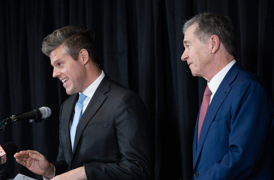 At an Aug. 7 press conference in Charlotte, N.C. Department of Health and Human Services Secretary Kody Kinsley, left, and Gov. Roy Cooper, right, spoke of the urgency of relieving patient medical debt. “The emotional and financial burden of this debt rests heavy on the people of North Carolina,” Kinsley said.