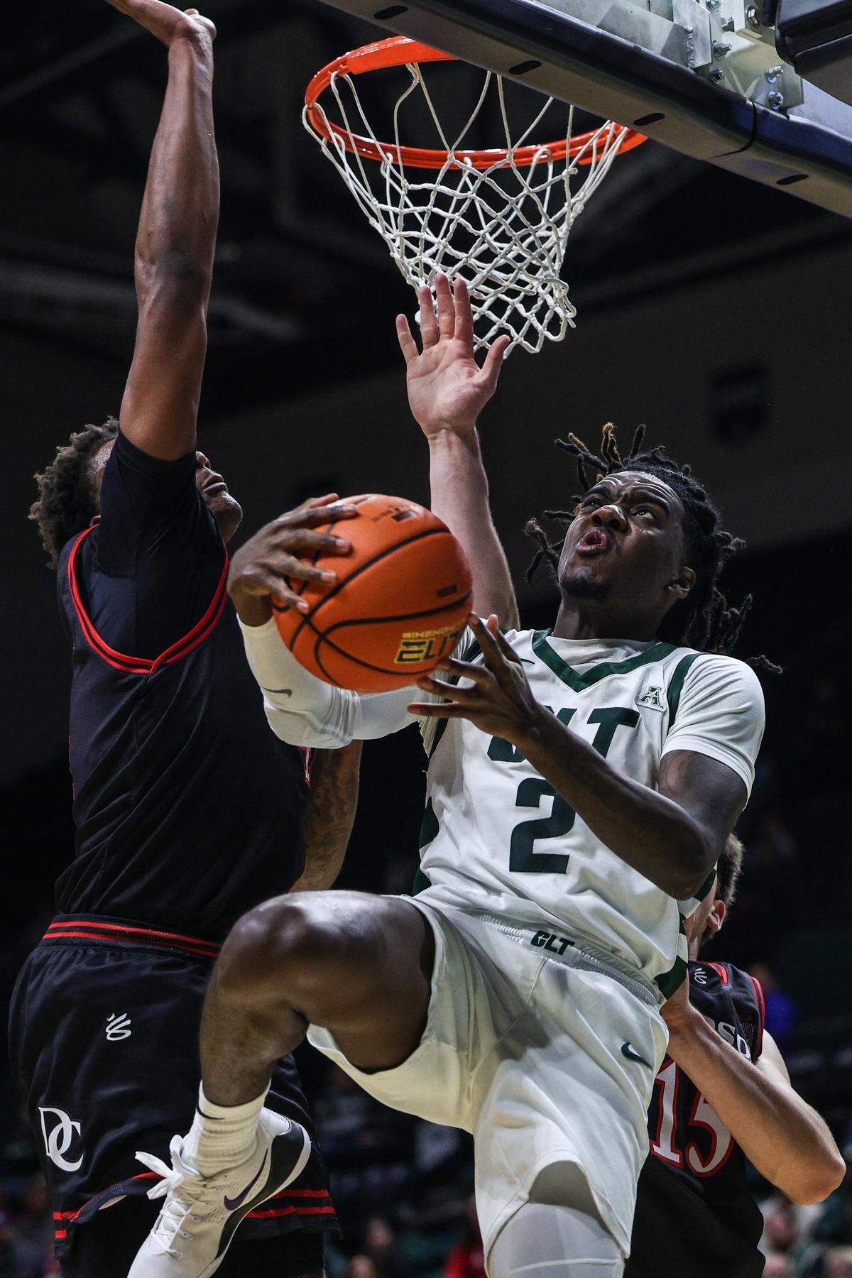Charlotte guard Dezayne Mingo, right, pushes through Davidson’s defense as he charges toward the basket in the paint during their Nov. 11, 2025 game at Dale F. Halton Arena in Charlotte.