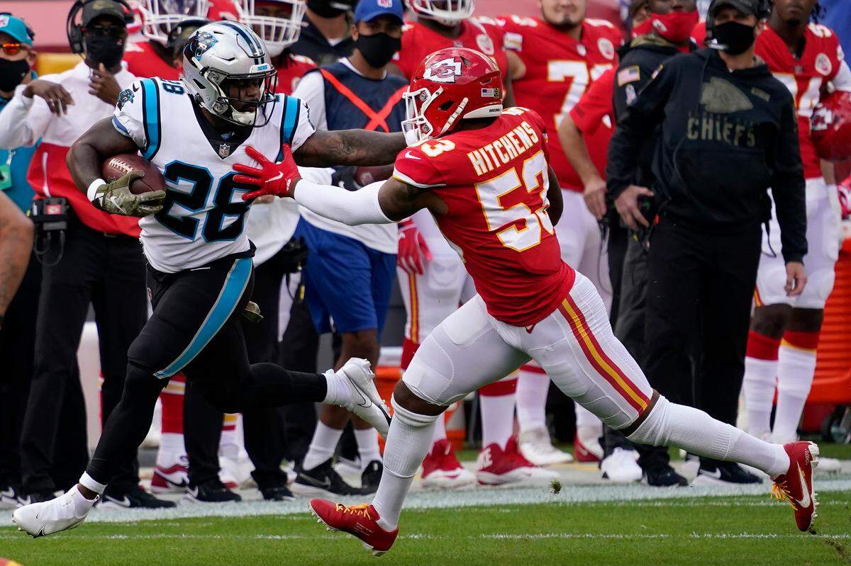 Carolina Panthers running back Mike Davis (28) runs against Kansas City Chiefs inside linebacker Anthony Hitchens (53) during the first half of an NFL football game in Kansas City, Mo., Sunday, Nov. 8, 2020. (AP Photo/Jeff Roberson)