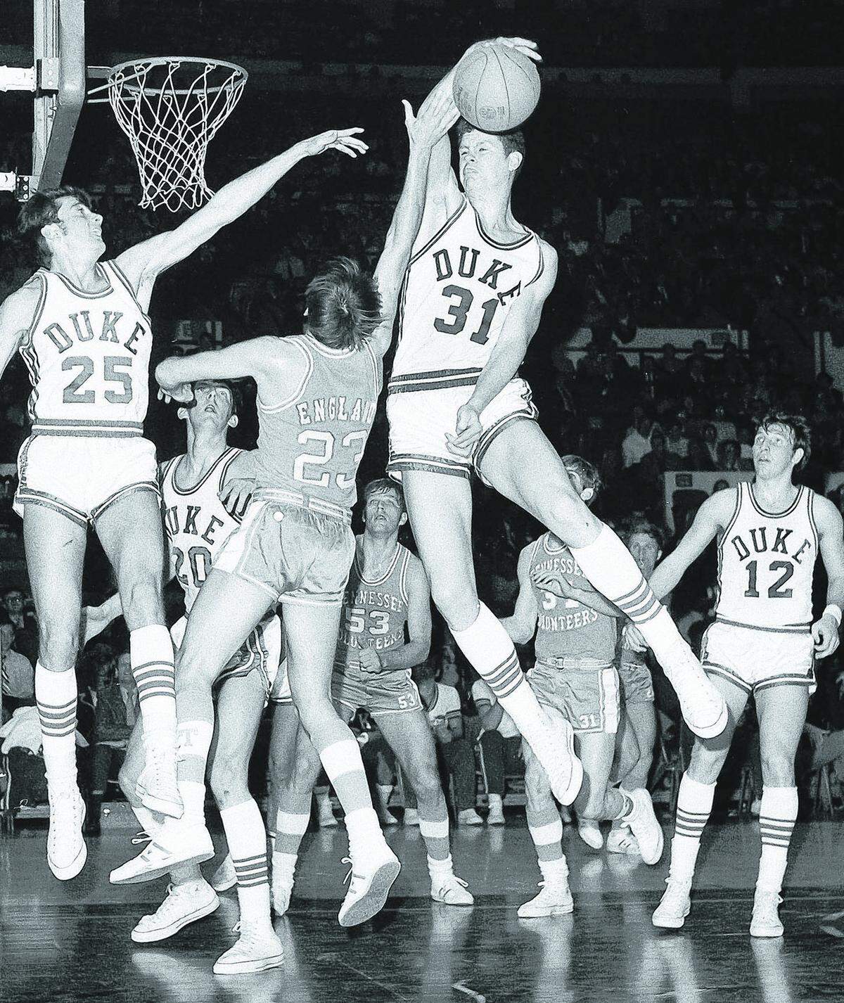 Tennessee player Jimmy England (23) has his shot blocked by Duke’s Randy Denton (31), right, in National Invitation Tournament game at New York’s Madison Square Garden on March 23, 1971. Duke won the game, 78-64, but would lose in the NIT semifinal to UNC later the same week.