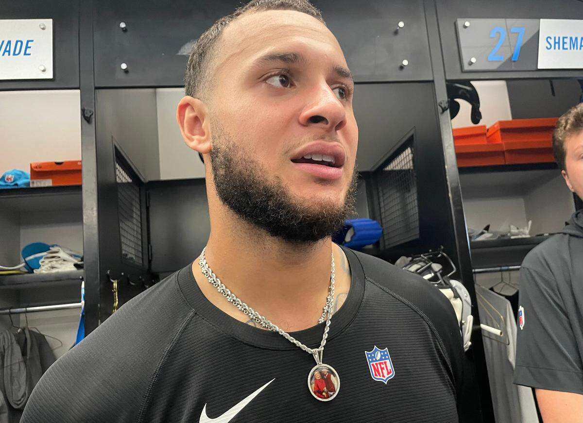 Caleb Farley speaks after signing with the Carolina Panthers’ practice squad in October 2024. He wears a locket with his deceased parents, his mother Robin and his father Robert, over his heart.