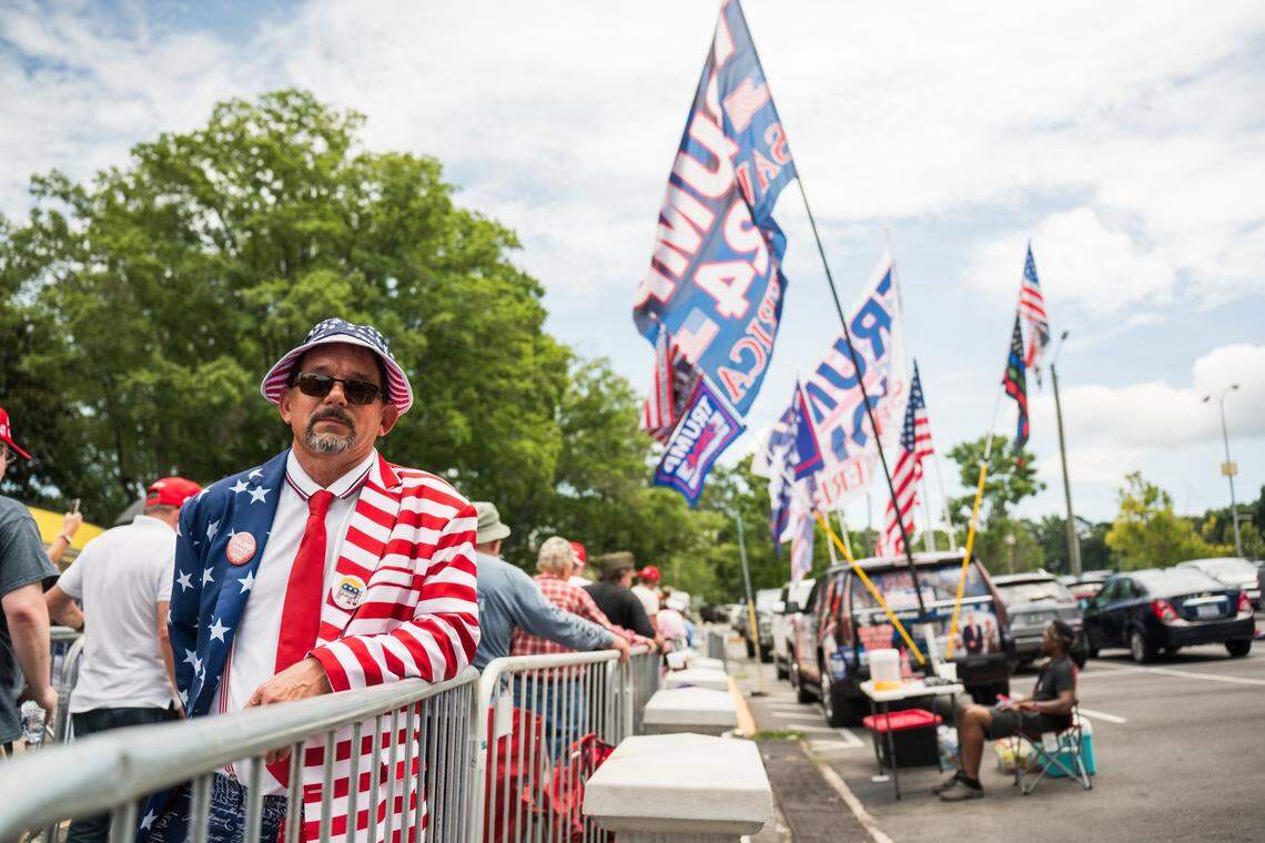 A supporter for former President Donald Trump waits inline to get in side the Bojangles Coliseum in Charlotte on Wednesday, July 24, 2024.
