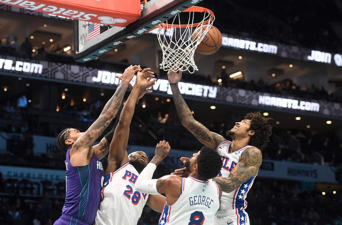 Charlotte Hornets center Nick Richards (4) and Philadelphia 76ers forward Guerschon Yabusele (28), forward Paul George (8) and forward Kelly Oubre Jr (9) go after a rebound during the second half at the Spectrum Center.