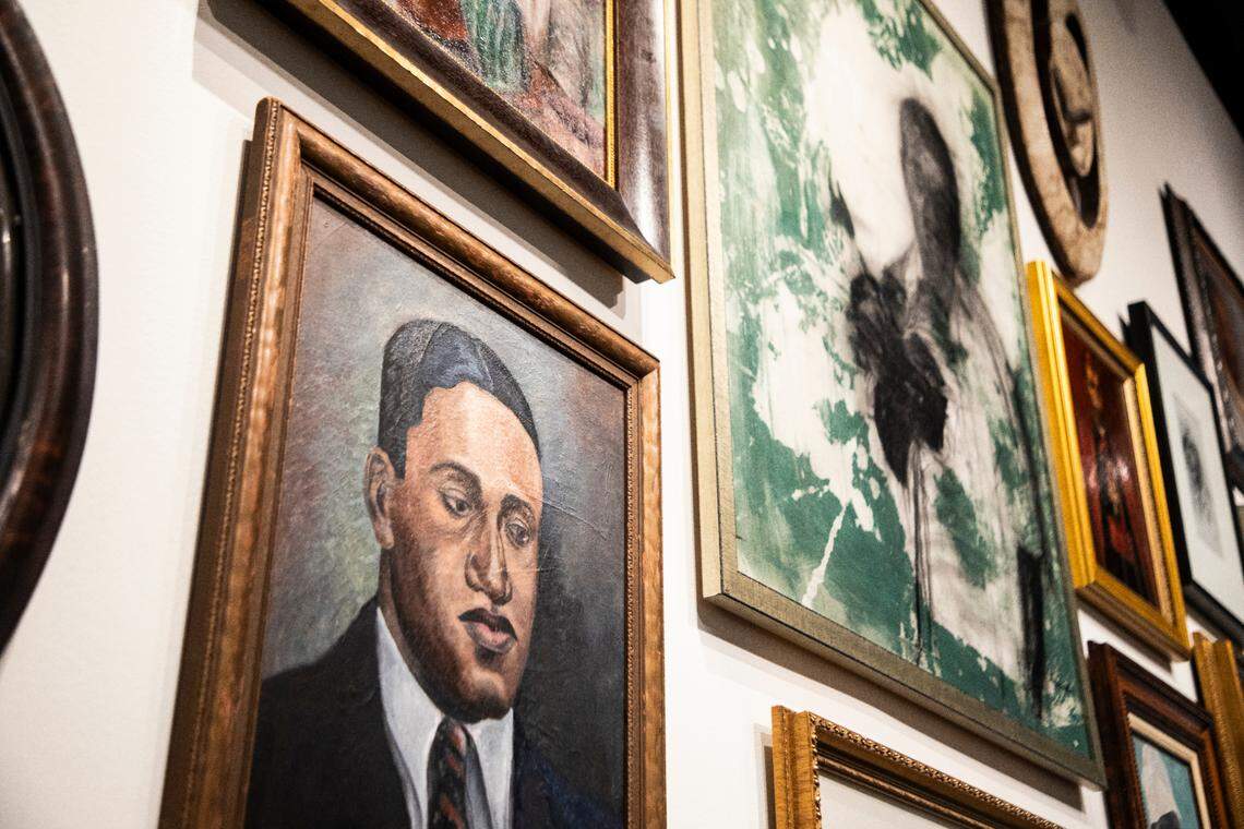 A wall of art from four local couples welcomes people into “The Vault” exhibit at the Mint. It runs through Sept. 17.