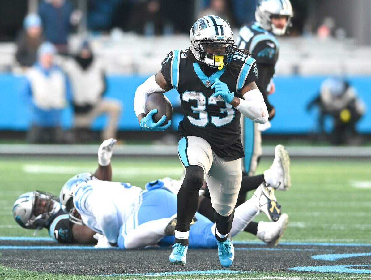 Carolina Panthers running back D’Onta Foreman, center, rushes up the middle for yardage against the Detroit Lions during fourth quarter action at Bank of America Stadium on Saturday, December 24, 2022 in Charlotte, NC. The Panthers defeated the Lions 37-23.