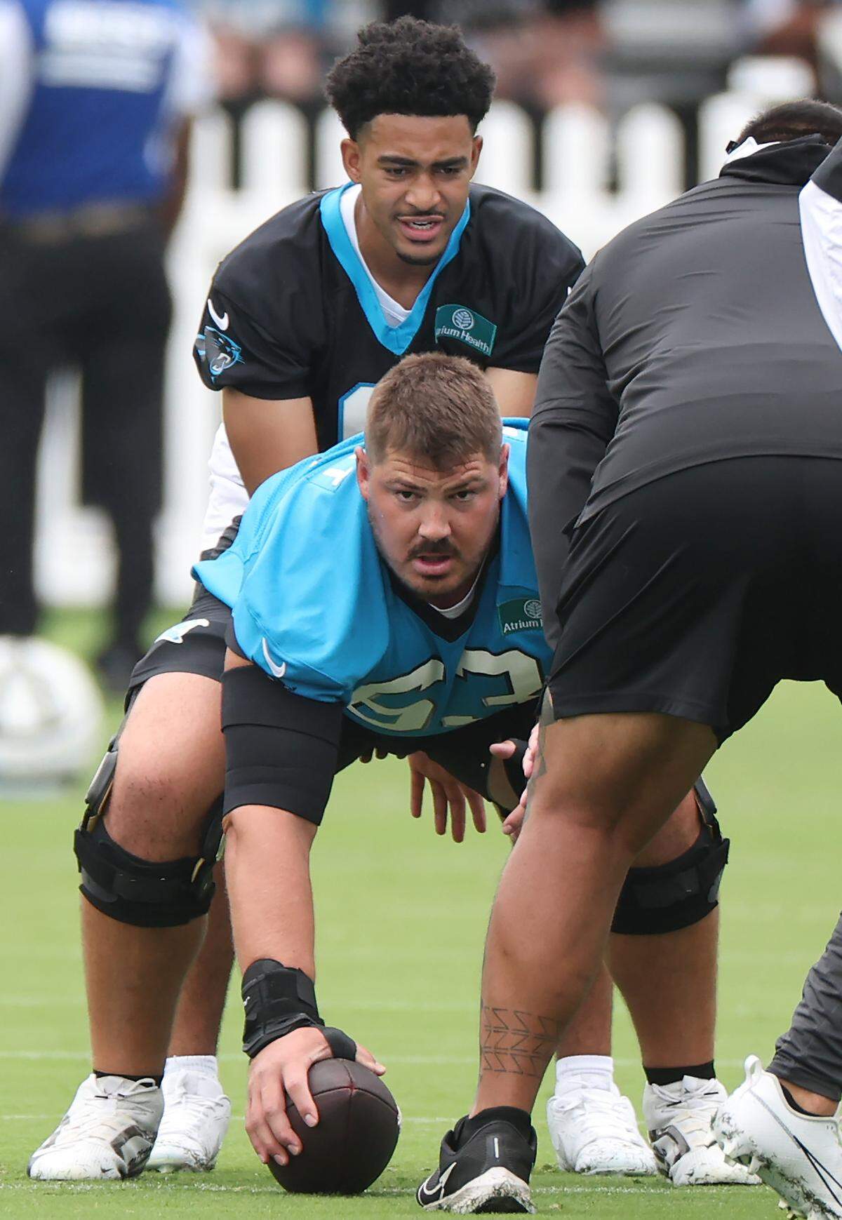 Carolina Panthers center Austin Corbett prepares to hike the ball to quarterback Bryce Young during training camp practice on Thursday, July 25, 2024.